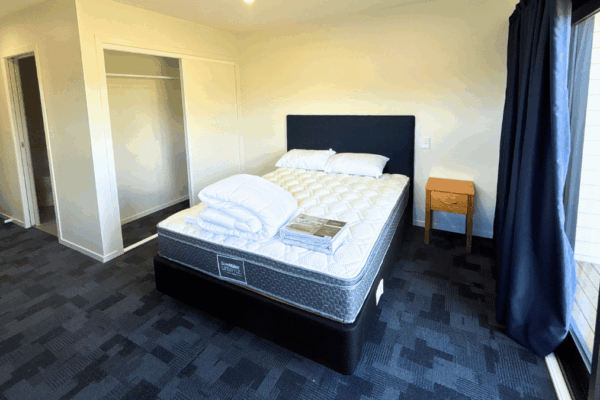 15 Transbuild Commercial Developer Series transportable home photo of bedroom with bathroom and storage