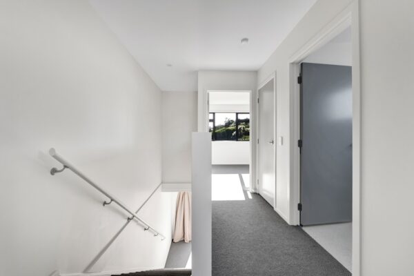24_800px Upstairs hallway and stairs view of a developer series transbuild commercial home