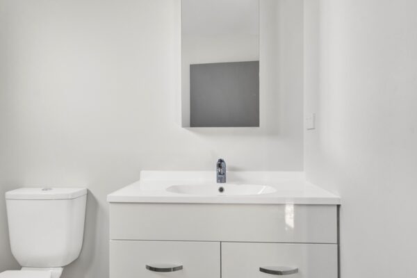 26_800px View of toilet and sink area in a bathroom in a developer series transbuild commercial home