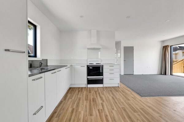 37_800px Large open plan living space with lounge and kitchen view in a transbuild commercial developer series home