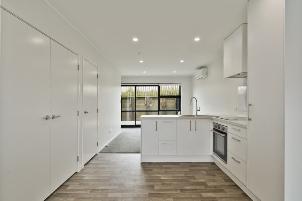Transbuild 2B_Living_LR03 View inside the kitchen and dining space of a transbuild developer series home with heatpump and storage space
