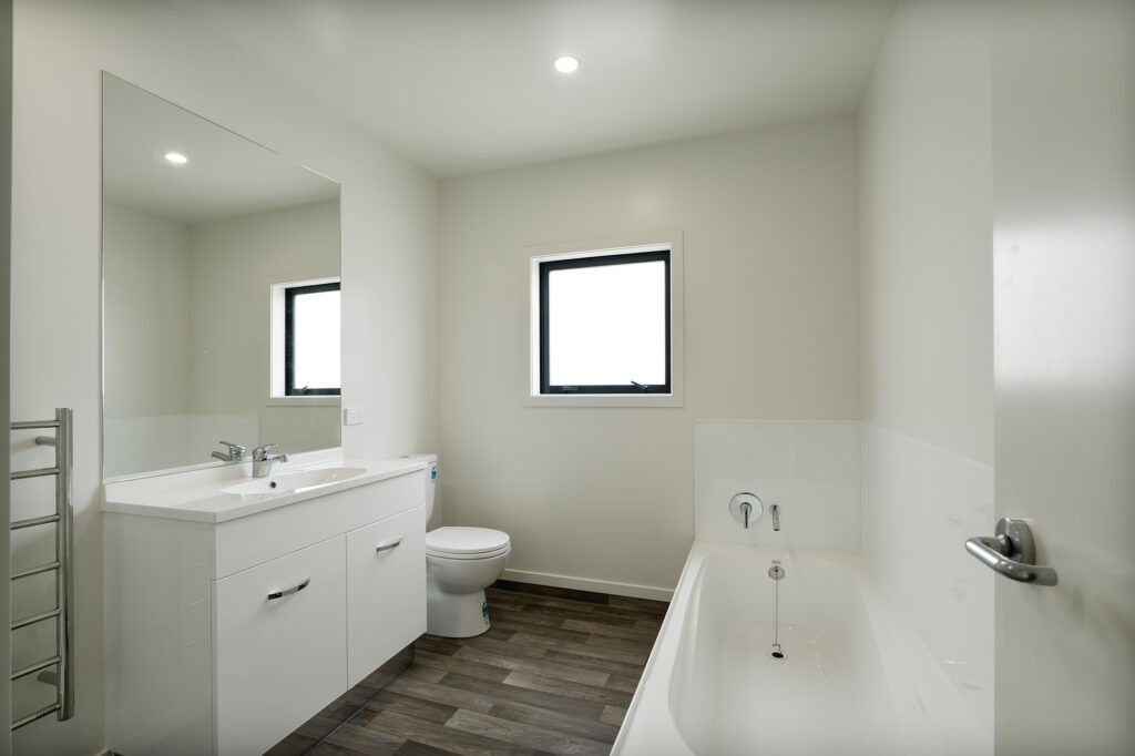 Transbuild 3B_BatLRoom_LR01 View inside the bathroom of a transbuild developer series home bathroom with bath and toilet
