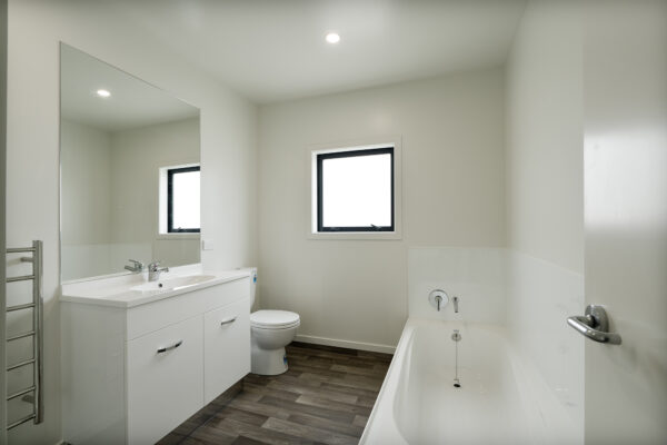 Transbuild 3B_BatLRoom_LR01 View inside the bathroom of a transbuild developer series home bathroom with bath and toilet