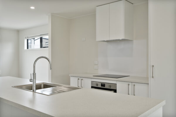 Transbuild 3B_Living_LR03 View inside a developer series home in the downstairs section kitchen area with island