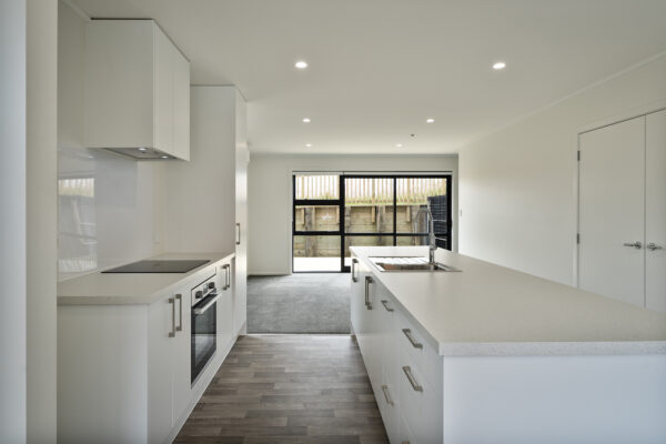 Transbuild 3B_Living_LR04 View inside a developer series home in the downstairs section kitchen area
