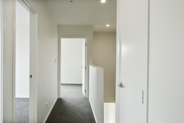 Transbuild 3B_Stairs_LR01 View inside a developer series home in the upstairs section of home