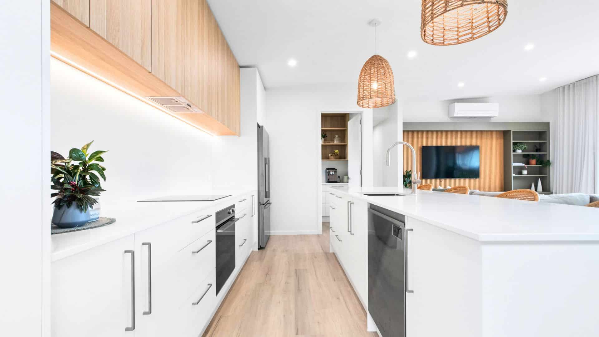 Light-filled Transbuild kitchen and living area with timber cabinetry and a generous island